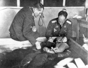 SS - Schutzstaffel(protection echelon) - Sturmbannfuehrer Dr. Sigmund Rascher (right) and Dr. Ernst Holzloehner(left) observe the reactions of a Dachau prisoner who has been immersed in a tank of ice water in an attempt to simulate the extreme hypothermia suffered by pilots downed over frigid seas.