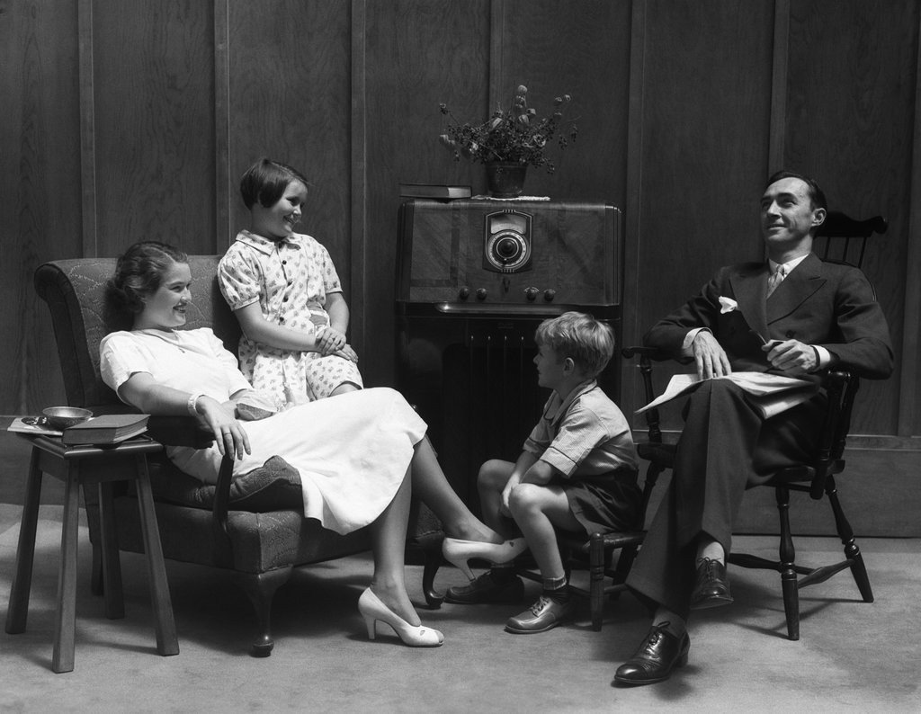 Family sitting around the radio
